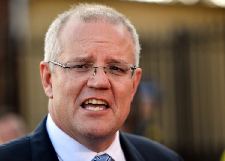 Australia's Prime Minister Scott Morrison talks to the media outside a polling booth during Australia's general election in Sydney on May 18, 2019. (Photo by Saeed KHAN / AFP)