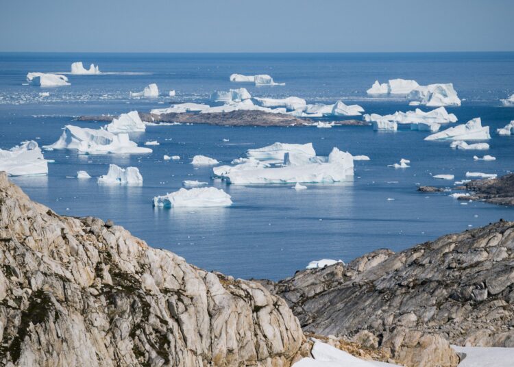 (FILES) In this file photo taken on August 15, 2019 an aerial photo taken on August 15, 2019 shows icebergs as they float along the eastern cost of Greenland near Kulusuk (aslo spelled Qulusuk). - Rising global temperature, rising sea levels, intensification of extreme events... The publication of the report of the Intergovernmental Panel on Climate Change (IPCC) is scheduled on August 9. (Photo by Jonathan NACKSTRAND / AFP)