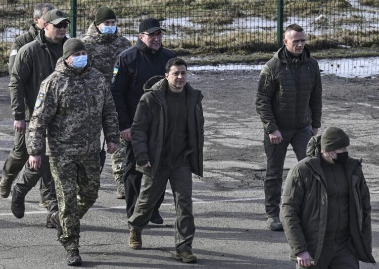 Ukrainian President Volodymyr Zelensky (C) arrives to attend a military drill outside the city of Rivne, northern Ukraine on February 16, 2022. (Photo by Aris Messinis / AFP)