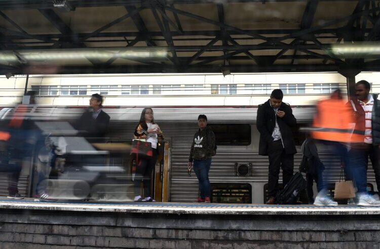 Passengers seen through the train window waiting at the plateform in central business district of Sydney on April 11, 2017. Thousands of passengers use Sydney's overcrowded rail network daily to reach their work places.