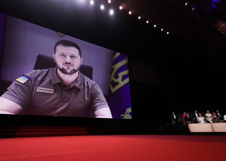 Ukrainian President Volodymyr Zelensky addresses guests during the Opening Ceremony of the 75th edition of the Cannes Film Festival in Cannes, southern France, on May 17, 2022. (Photo by Valery HACHE / AFP)