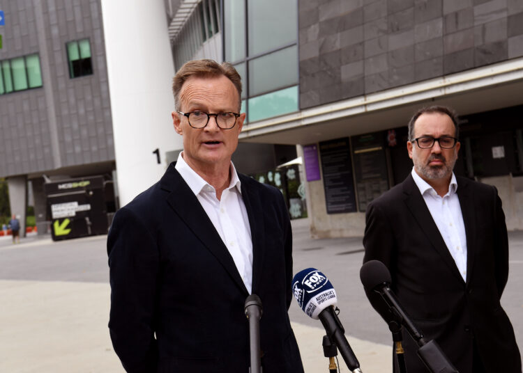 Cricket Australia Chair Lachlan Henderson (L) and Martin Pakula (R), Victorian Minister for Tourism, Sport and Major Events speak to the media in front of a statue of former Australian cricketing great Shane Warne outside the Melbourne Cricket Ground (MCG) in Melbourne on March 5, 2022. - Australia cricket great Shane Warne -- one of the best Test players of all time -- has died of a suspected heart attack aged 52. (Photo by William WEST / AFP)