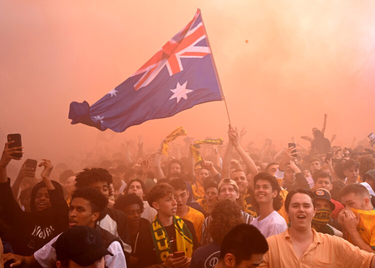 Australian Socceroos fans watch the Qatar 2022 World Cup Round of 16 football match between Australia and Argentina being shown on giant screens in a fan zone in Melbourne on December 4, 2022. (Photo by William WEST / AFP)