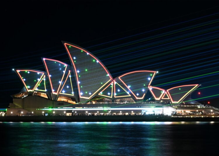 Laser beams illuminate the sails of Opera House Sydney on October 20, 2023, during celebrations to mark its 50th anniversary. (Photo by Saeed KHAN / AFP)