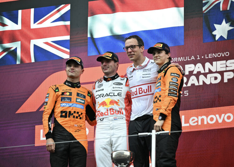 Winner Red Bull Racing's Dutch driver Max Verstappen (2nd L) poses with second-placed McLaren's British driver Lando Norris (L) and third-placed McLaren's Australian driver Oscar Piastri (R) on the podium after the Formula One Japanese Grand Prix at the Suzuka circuit in Suzuka, Mie prefecture, Japan on April 6, 2025. (Photo by Philip FONG / AFP)