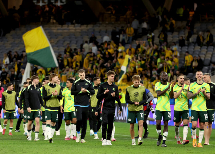 Australian players celebrate victory after the 2026 FIFA World Cup Asian Qualifier football match between Australia and Japan at Optus Stadium in Perth on June 5, 2025. (Photo by COLIN MURTY / AFP) / -- IMAGE RESTRICTED TO EDITORIAL USE - STRICTLY NO COMMERCIAL USE --