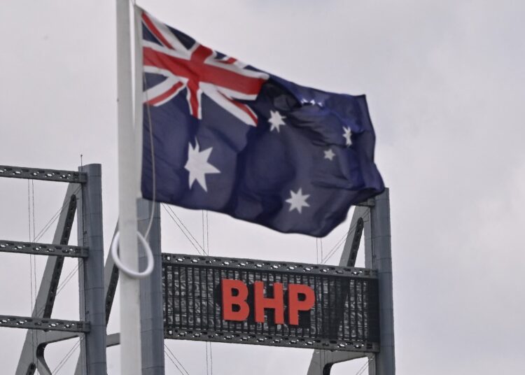 The logo of BHP, a leading global resources company, is seen on its building in Perth on November 24, 2025. Australian resources giant BHP said on November 24 it had dropped a bid to take over British rival Anglo American that would have created the world's largest miner of copper. (Photo by Saeed KHAN / AFP)