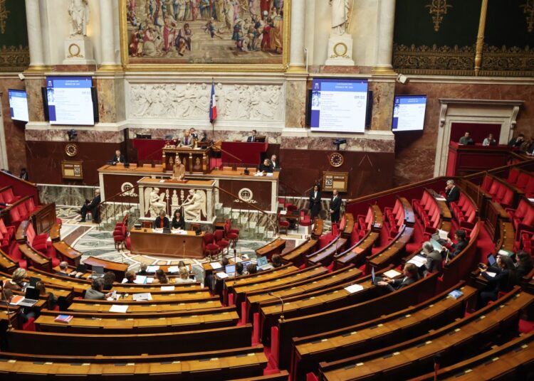 MPs attend a parliamentary debate on legislative process for a social media ban on under-15s at the Assemblee Nationale, France's lower house Parliament in Paris on January 26, 2026. French lawmakers are set to vote on draft legislation to ban social media for under-15s, an effort championed by President Emmanuel Macron as a way to protect children from excessive screen time. The legislation, which also provides for a ban on mobile phones in high schools, follows Australia banning social media for under-16s in December, a world first. As social media has grown around the world, so has concern that too much screen time is arresting child development and contributing to declining mental health in minors. (Photo by Ludovic MARIN / AFP)