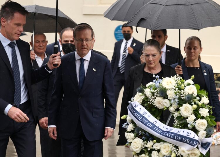 Israelli President Isaac Herzog (C) and his wife Michal (2nd R) are escorted by New South Wales Premier Chris Minns (L) as they lay a wreath for the victims of the December 14, 2025 gun attack at the Bondi Pavilion, in Sydney on February 9, 2026. Herzog said February 9 people of all faiths will "overcome this evil" as he paid respect to victims of a shooting that killed 15 people celebrating a Jewish festival on Sydney's Bondi Beach. (Photo by David GRAY / AFP)